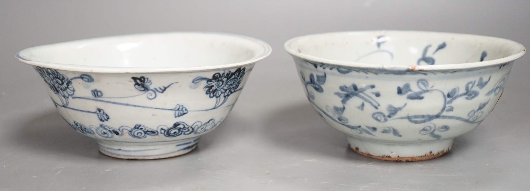 Two Chinese late Ming blue and white bowls, 16th/17th century, painted with flowers and foliage, 14.3 and 15.8cm